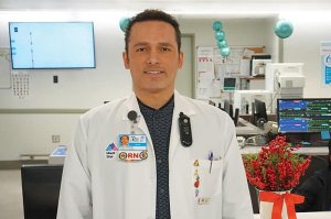 A male doctor is pictured in a white coat.